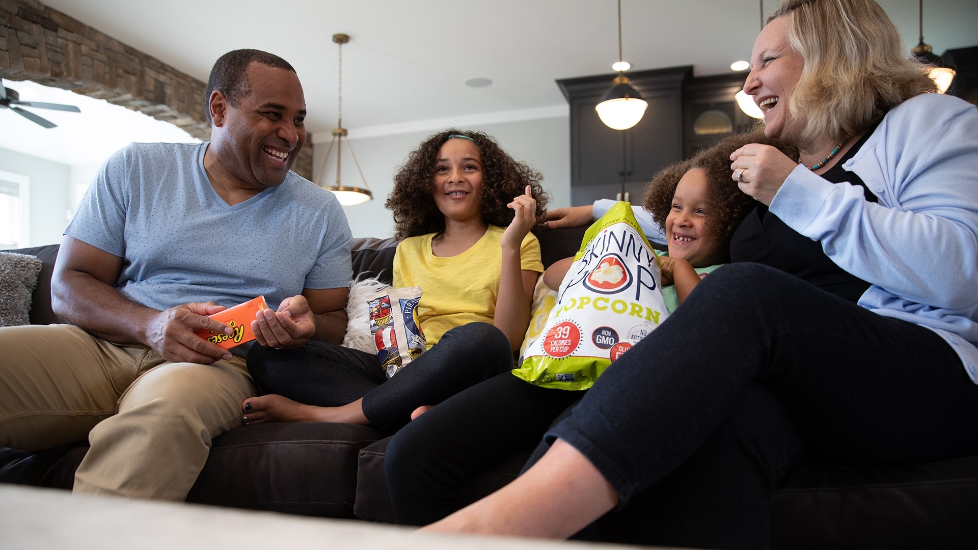 Family laughing and enjoying snacks