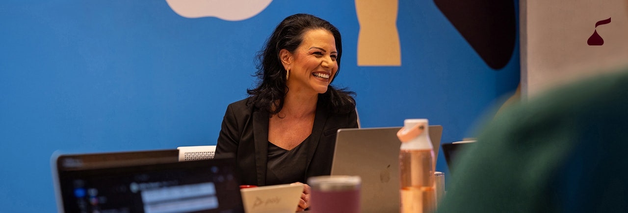 Person working on their laptop in a meeting