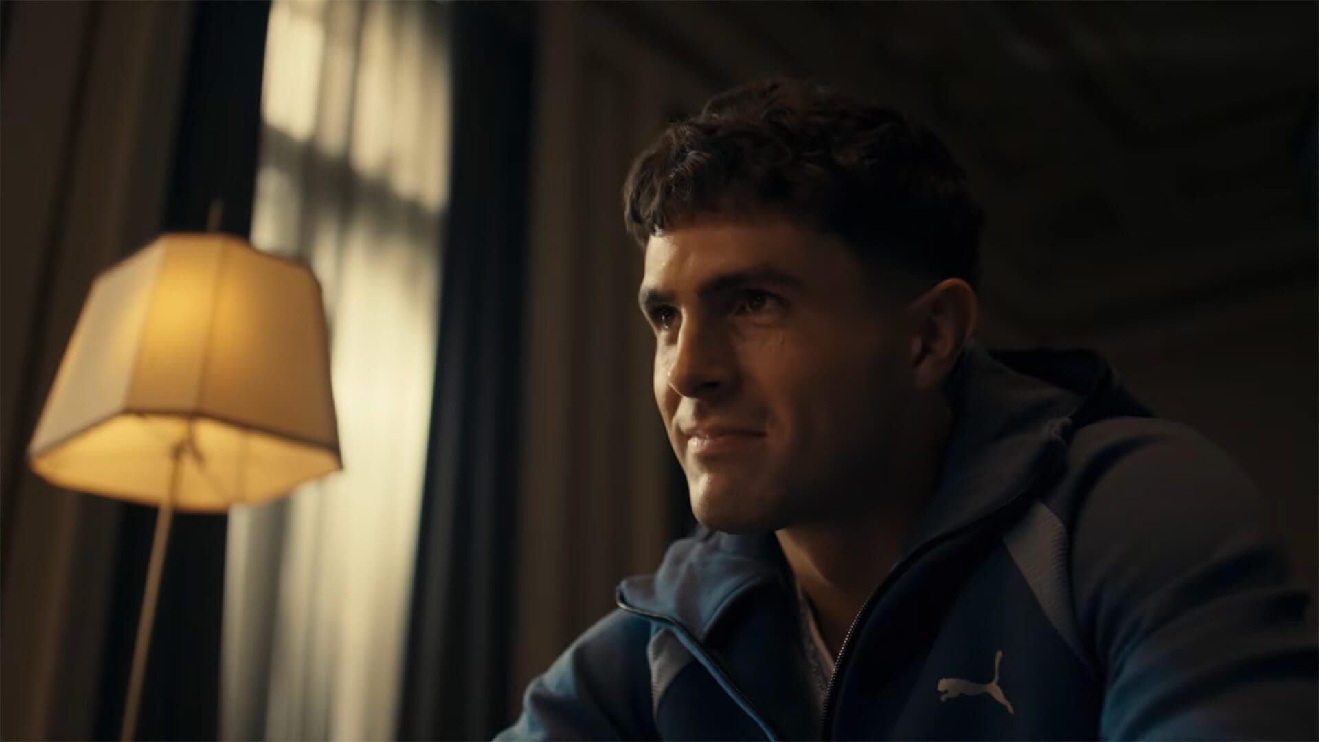 Christian Pulisic opening up box of hersheys milk chocolate bars with his name on them