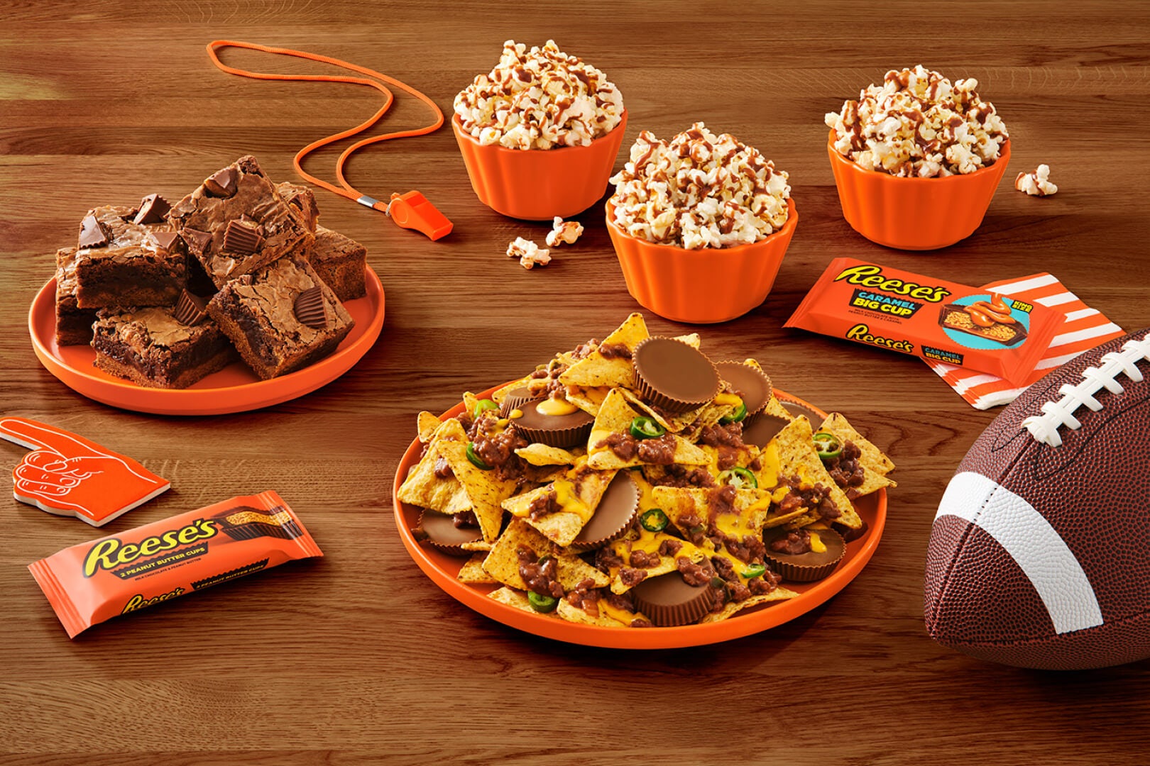 game day snacks made using reese's cups on a table with a football and other sports themed items